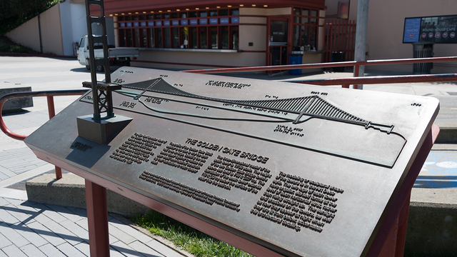 The renovated visitor plaza features expanded gathering spaces and interpretive exhibits about the bridge