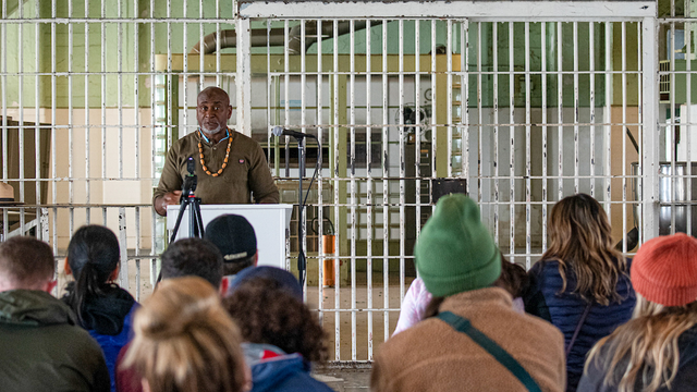 A formerly incarcerated speaker lectures in the Alcatraz Dining Hall