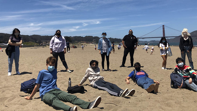 Youth who participated in the My Park Moment photo show curation on the beach near the Golden Gate Bridge.