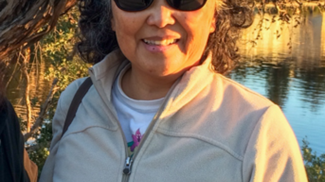 A portrait of a woman outdoors surrounded by nature