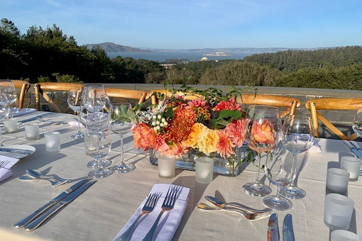 Dinning table set before a scenic San Francisco view at the Presidio.