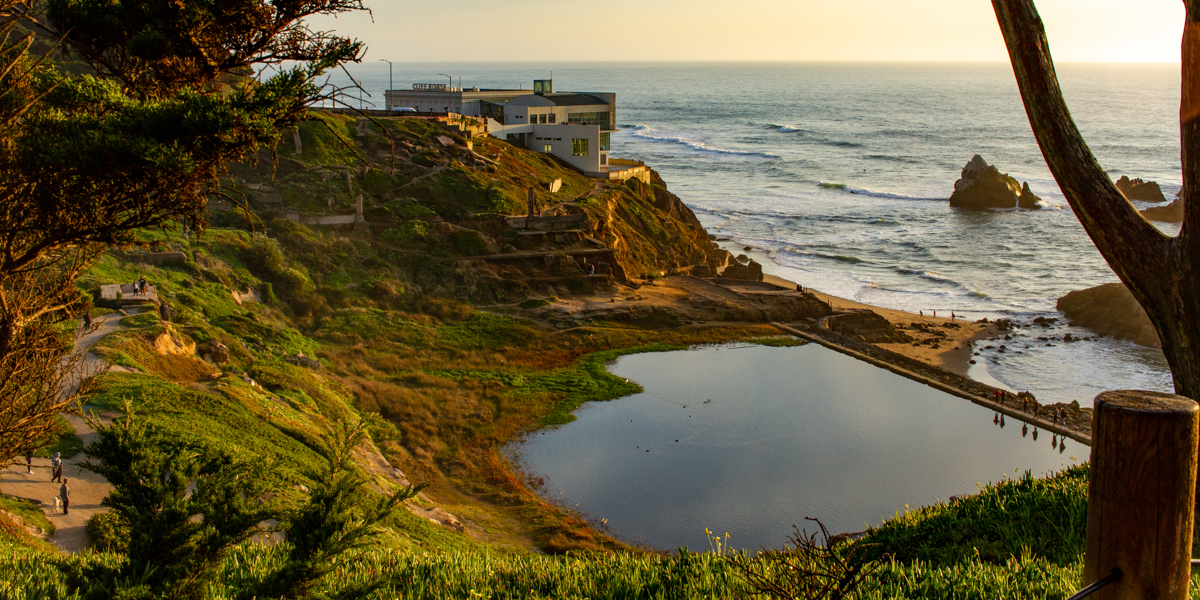 A sunset view overlooking Lands End, the ruins of Sutro Baths, and the ocean.