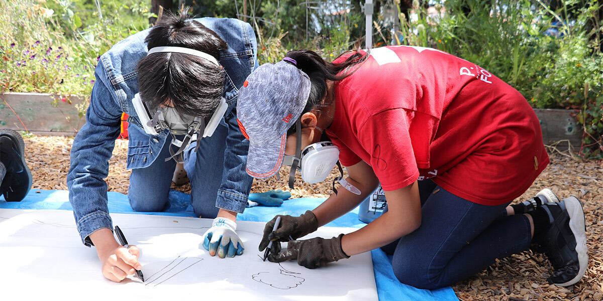 Two youth working on a project together