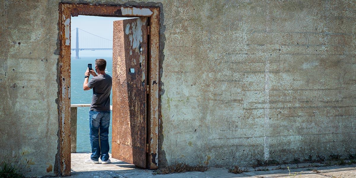 A visitor takes a photo on Alcatraz Island. A visitor takes a photo on Alcatraz Island.