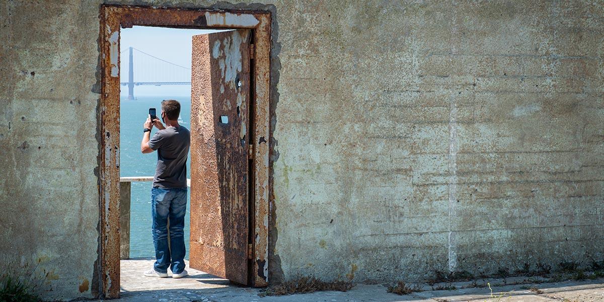 A visitor takes a photo on Alcatraz Island.