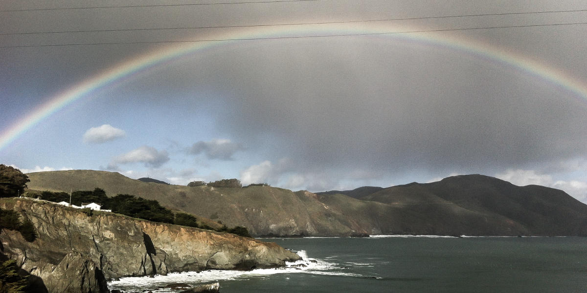 A rainbow shines over the headlands