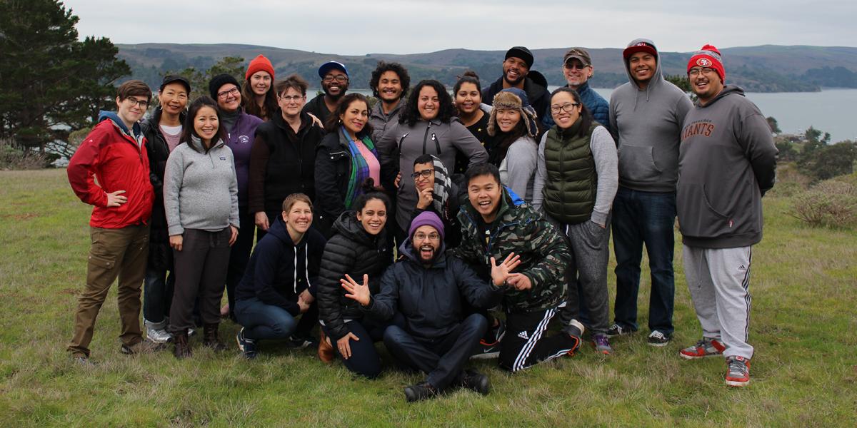 Crissy Field Center Educators and Staff Members A group of educators stand on a grassy hillside overlooking an estuary.