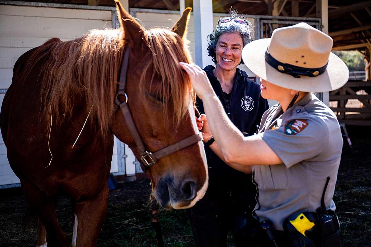 Lainie Motamedi and Park Ranger Katlyn Grubb at the Horse Mounted Patrol Stables in the Marin Headlands.