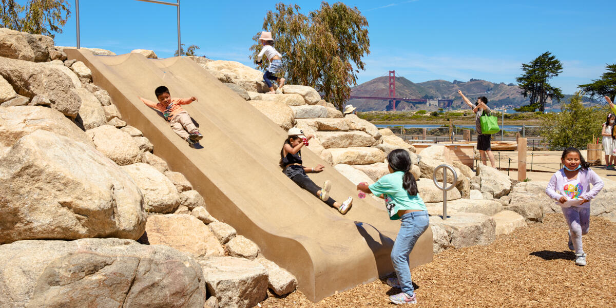 Children playing on Bluff Slide at Outpost