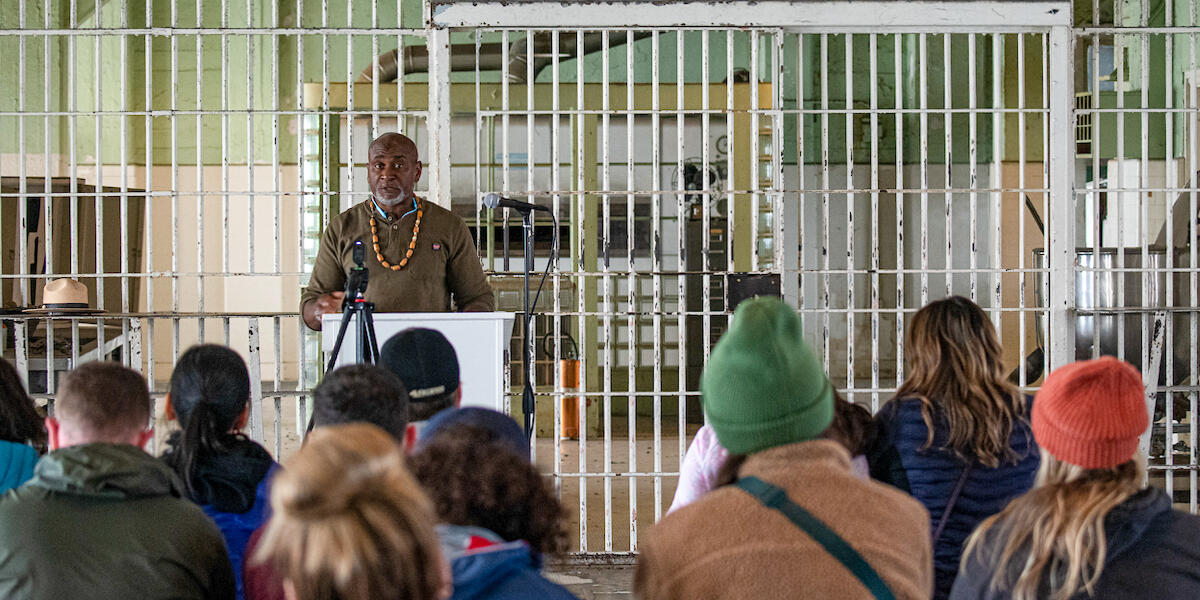 A formerly incarcerated speaker lectures in the Alcatraz Dining Hall