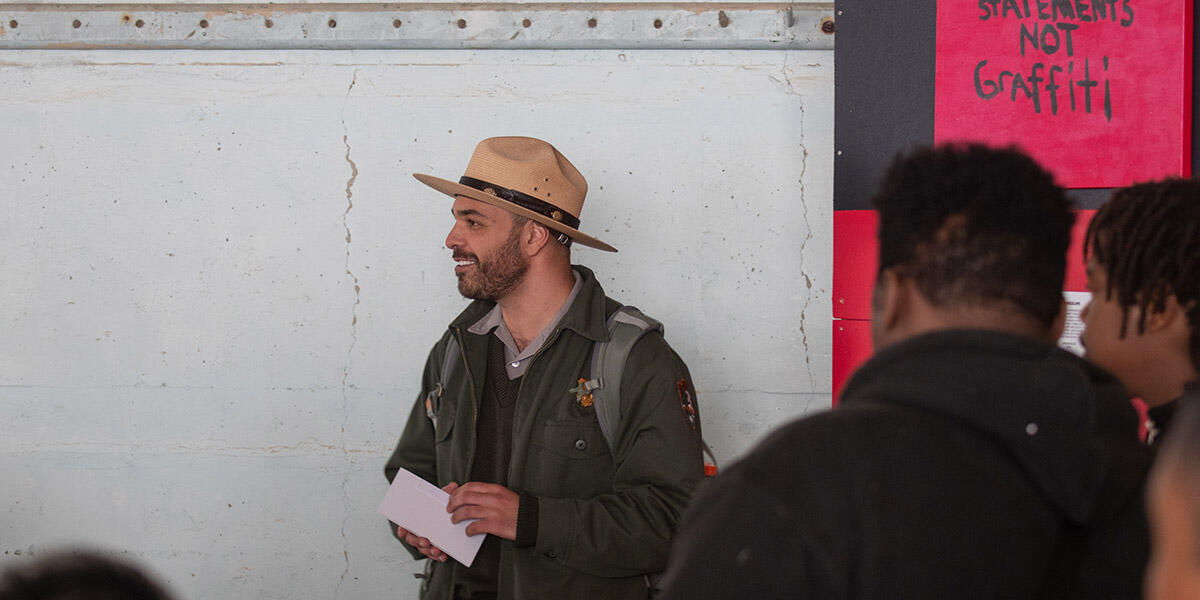 A park ranger smiling during a program on Alcatraz Island.