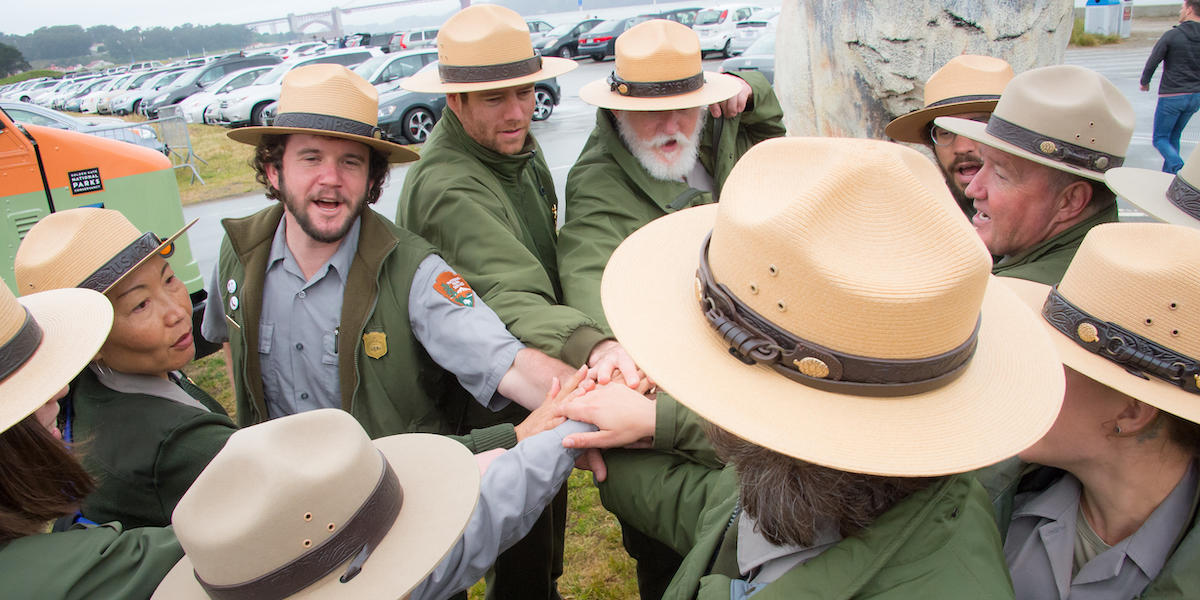 A group of NPS rangers rally together during the Junior Ranger Jamboree in 2016.