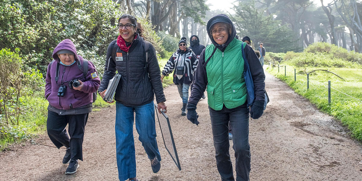 A group of people walking down a path at Lands End in San Francisco.