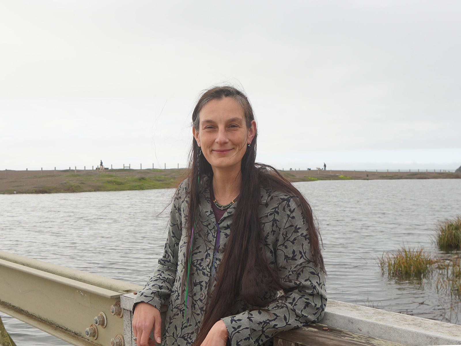 Portrait of Data manager Lizzy Edson smiling on the bridge by Rodeo Lagoon.