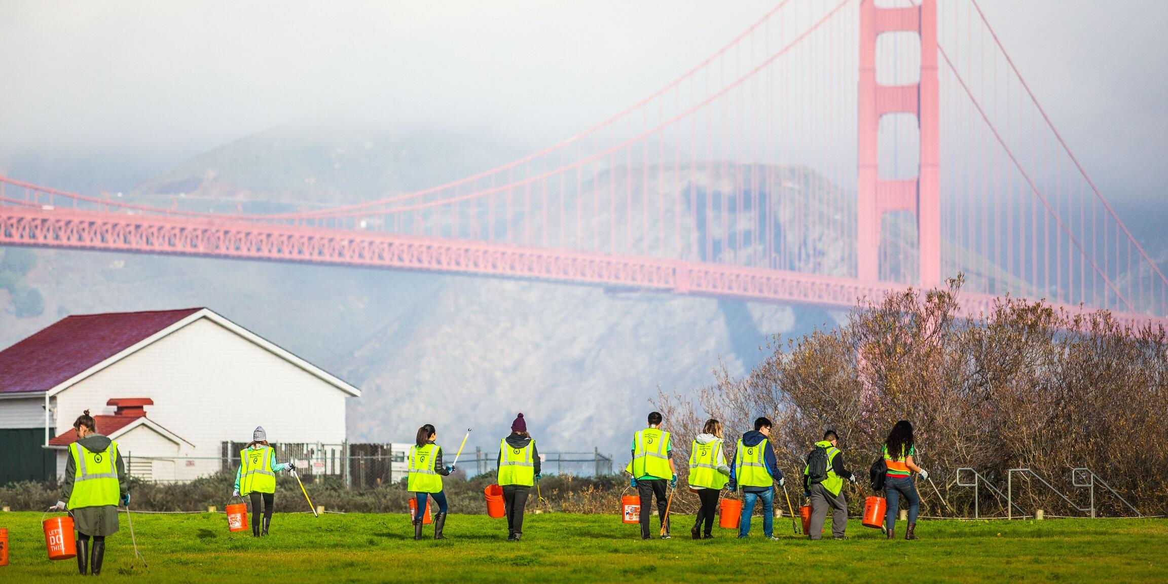Volunteers clean up Crissy Field in the Presidio of San Francisco, right next to the Golden Gate Bridge.