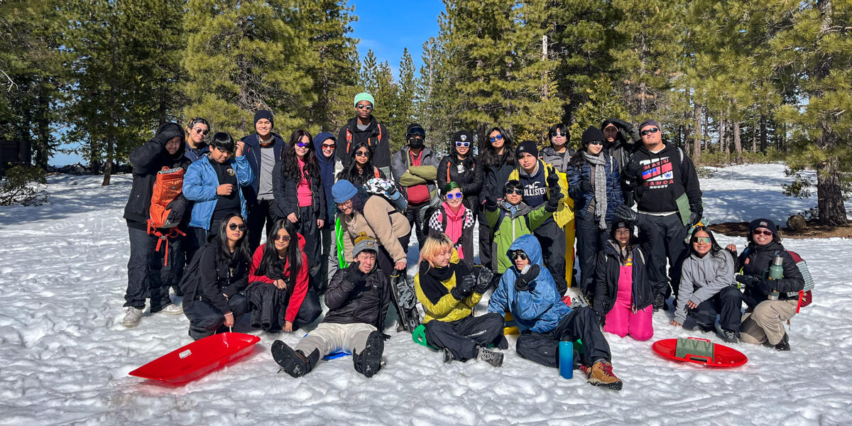 Crissy Field Center IYEL youth participants pose for a group photo in the snow during their winter trip.