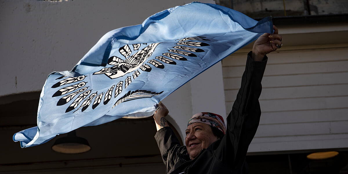 woman waves banner