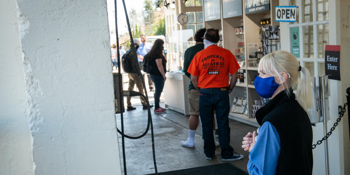 Masked workers prepare to assist visitors for the re-opened tours of Alcatraz Island.