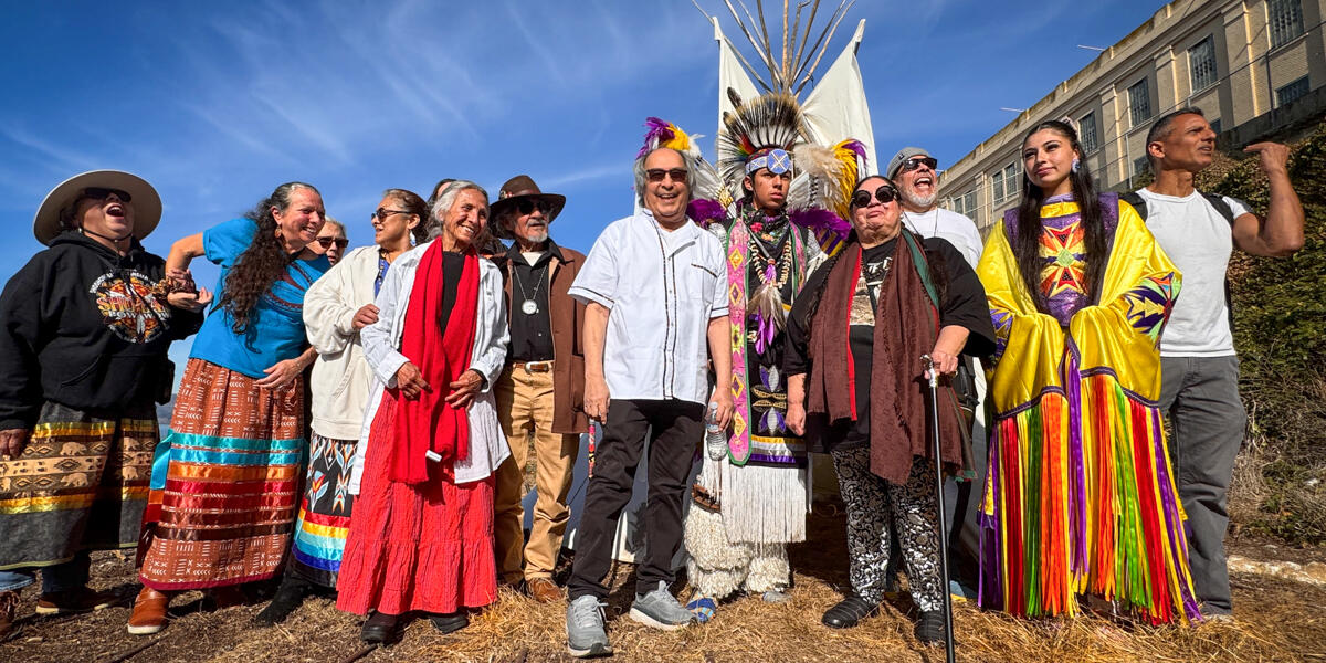 A group photo of people honoring indians of all tribes gathered on indigenous peoples day tipi ceremony
