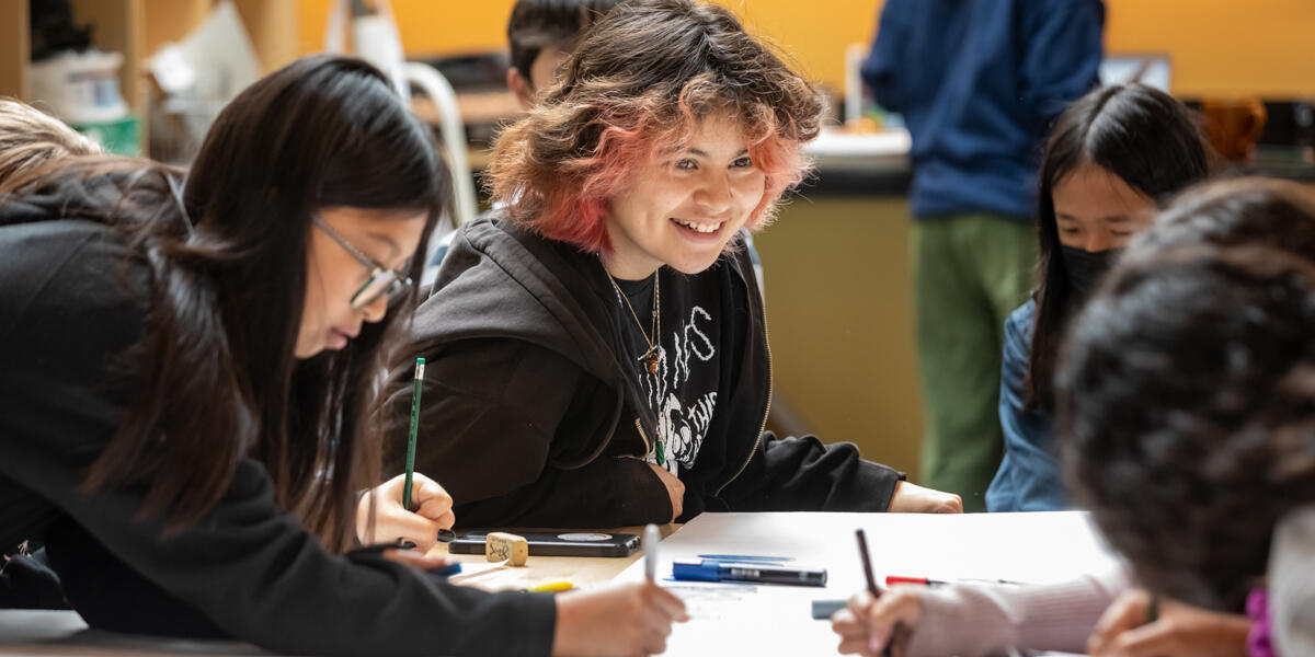 Crissy Field Center youths smiling as they create artwork