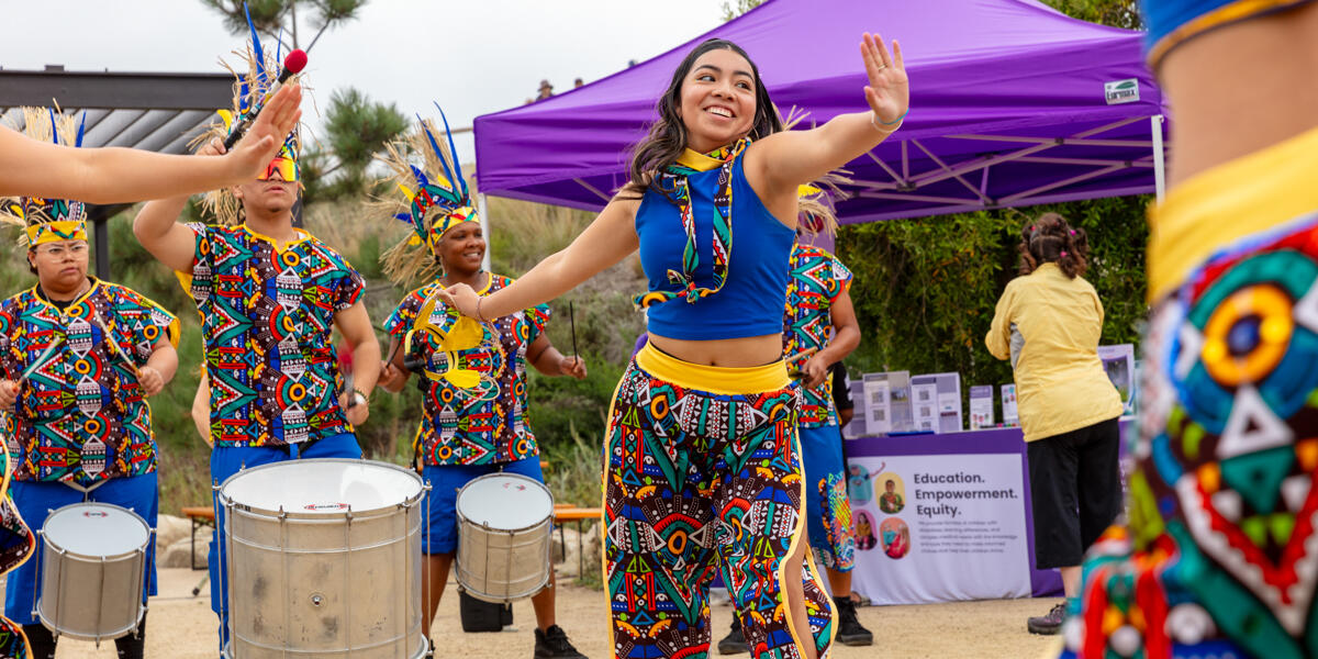 Colorfully dressed Fogo Na Roupa dancers and band performing at the Presidio Tunnel Tops