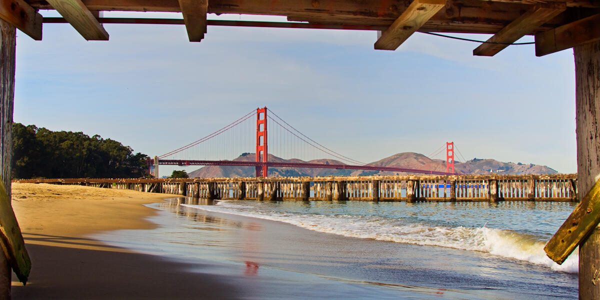 A view of the Golden Gate Bridge from beneath the pier of Crissy Field East Beach.