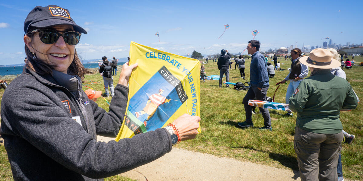 Parks Conservancy staff displays the original commemorative kite from the opening of Crissy Field