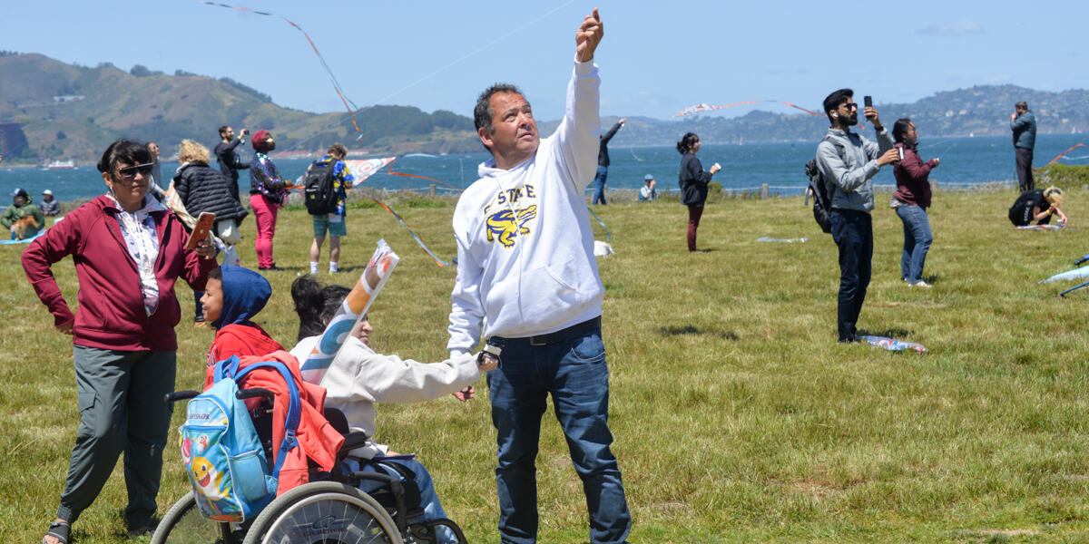 A family enjoys flying a kite at Crissy Field.