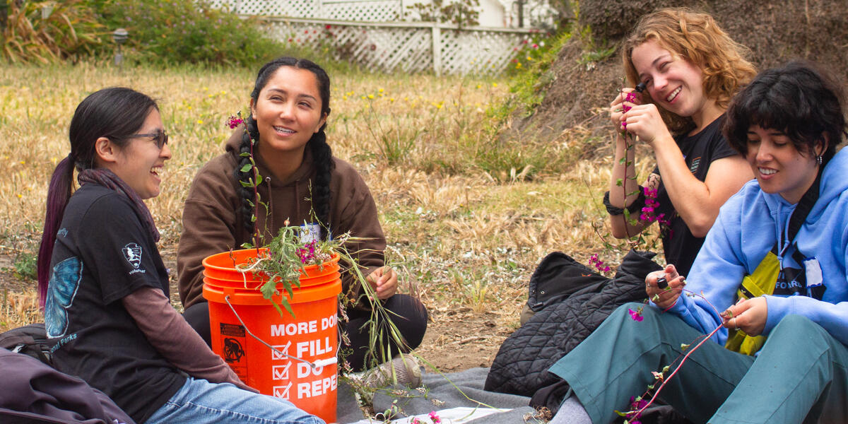 Academic Interns smiling and enjoying the task of identifying native plant species.