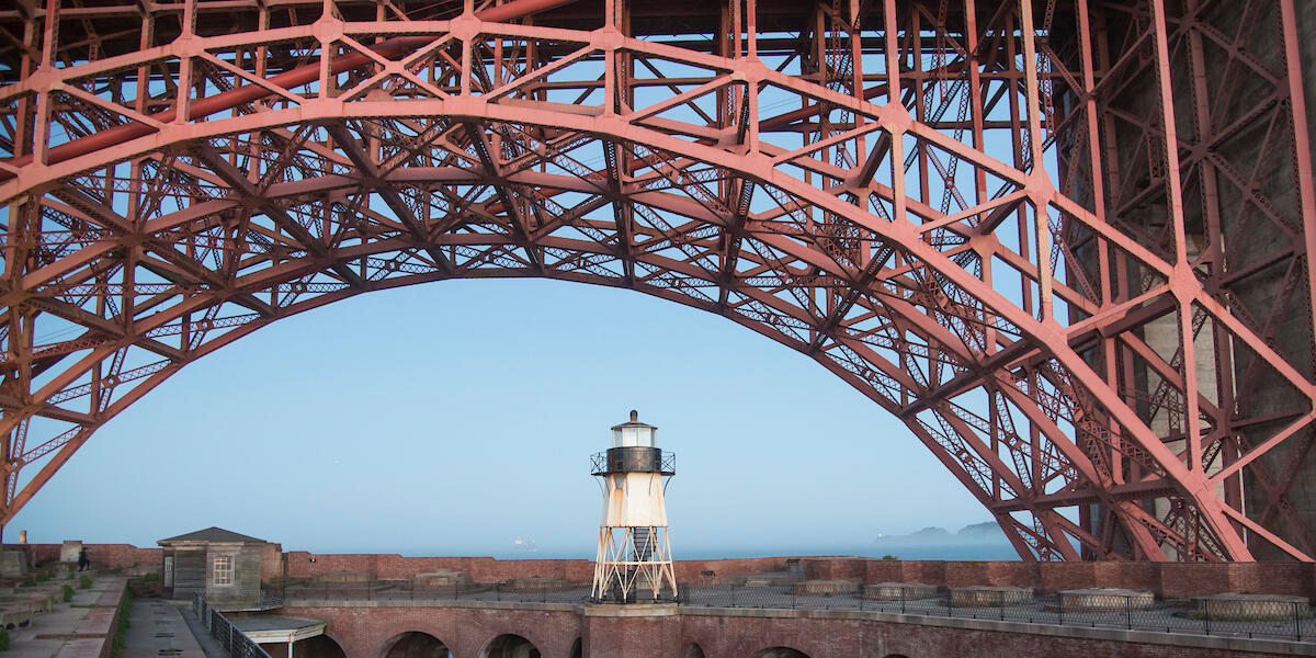 The arch of the Golden Gate bridge over Fort Point.