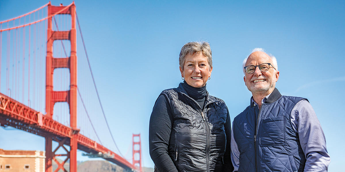 Christine Lehnertz (left), current President & CEO of the Golden Gate National Parks Conservancy, and CEO Emeritus and Special Advisor Greg Moore (right) with Golden Gate Bridge in background.