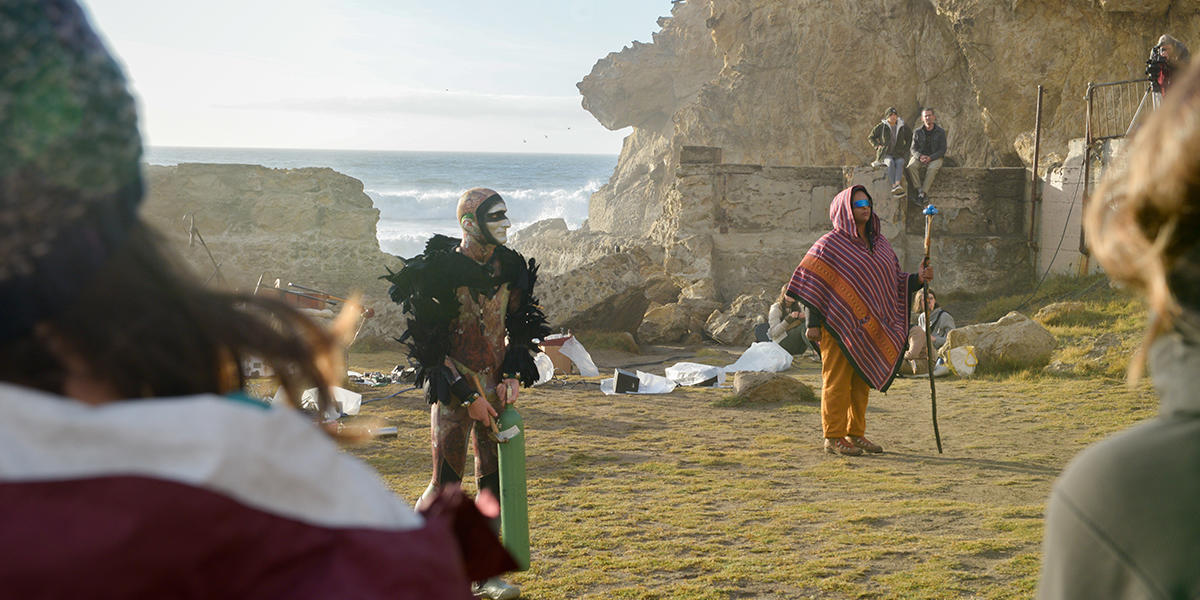 Musicians stand before a crowd at Sutro Baths