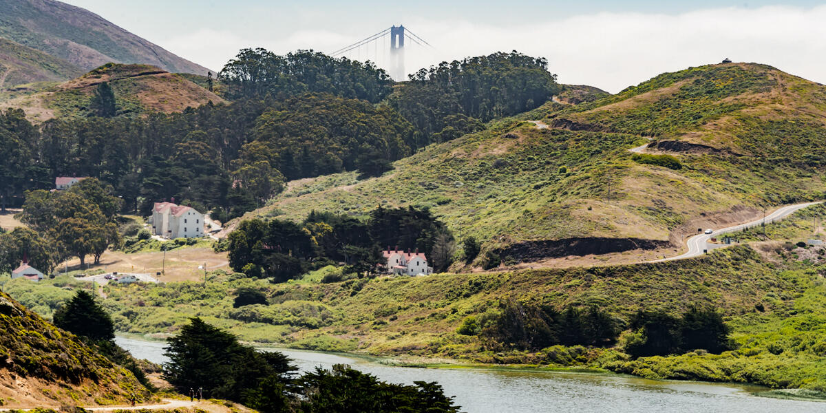 The Golden Gate Bridge peers over the mountains and into the valleys of the Marin Headlands.