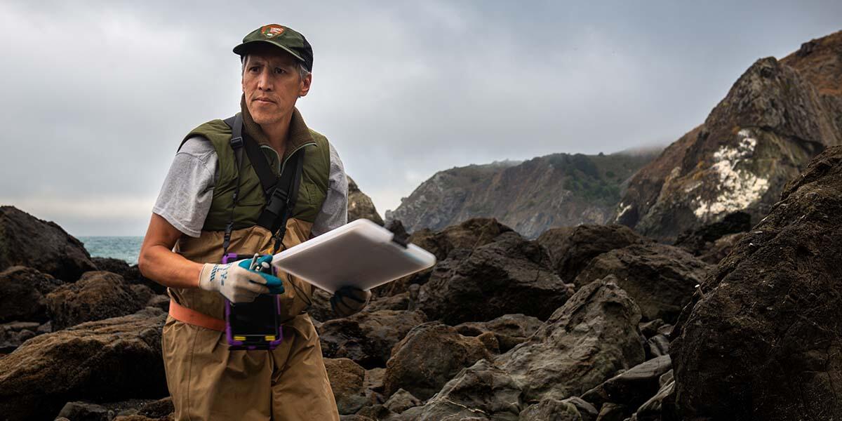 National Park Service Aquatic Ecologist Darren Fong surveys tide pools in Marin County.