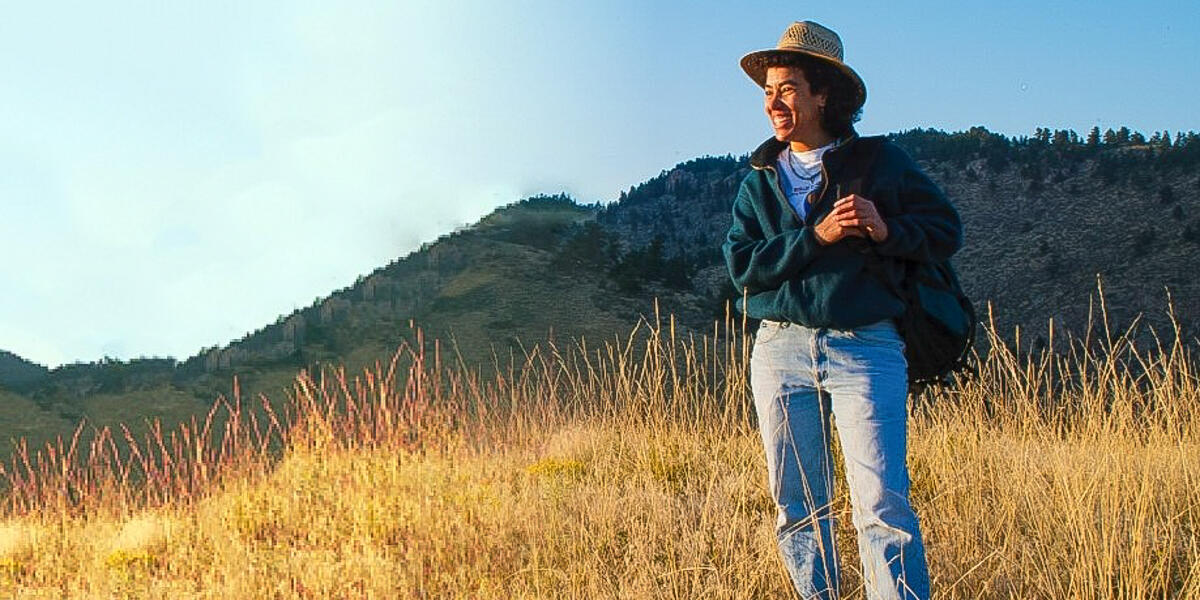 Dr. Nina Roberts stands in a field with Mount Tamalpais in the background.