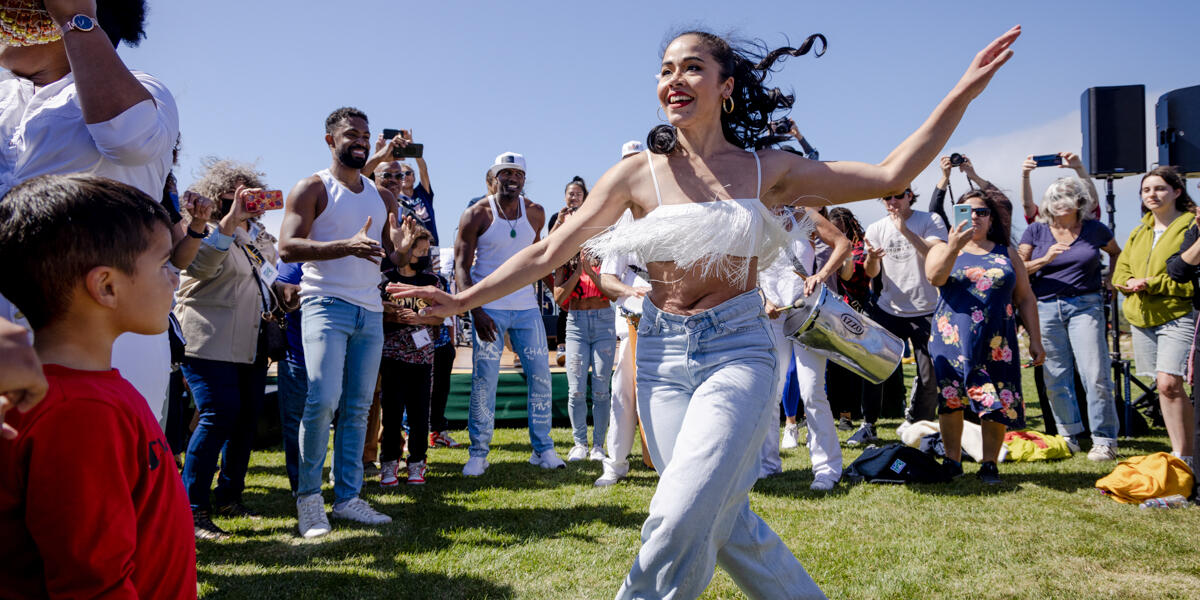 A dancer dances amongst the crowd at the Presidio Tunnel Tops.