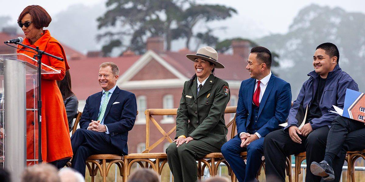 Speakers on a stage at the Presidio.