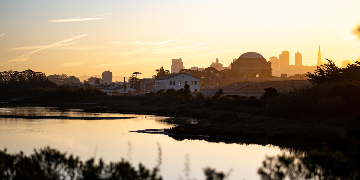 The sun rising over Crissy Marsh, beaming about the San Francisco skyline.