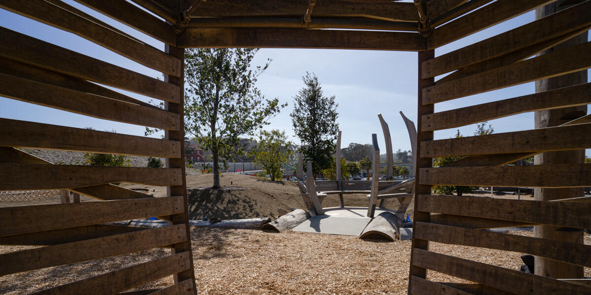 A view looking out from inside of one of the wooden play structures at the Outpost at Presidio Tunnel Tops.