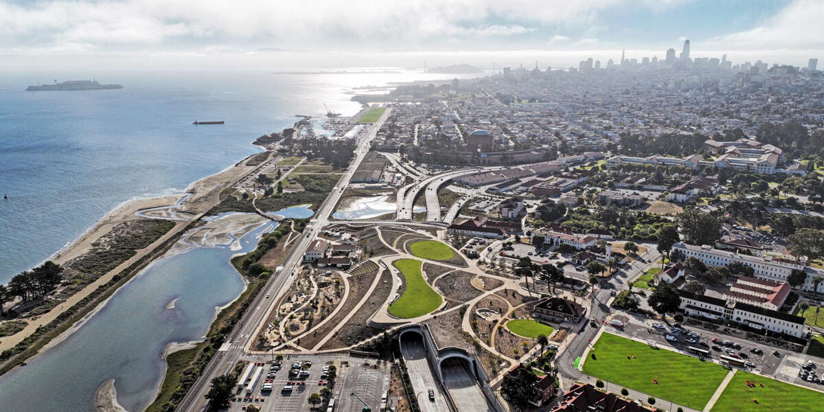 Aerial view of the Presidio Tunnel Tops and San Francisco on a sunny day.