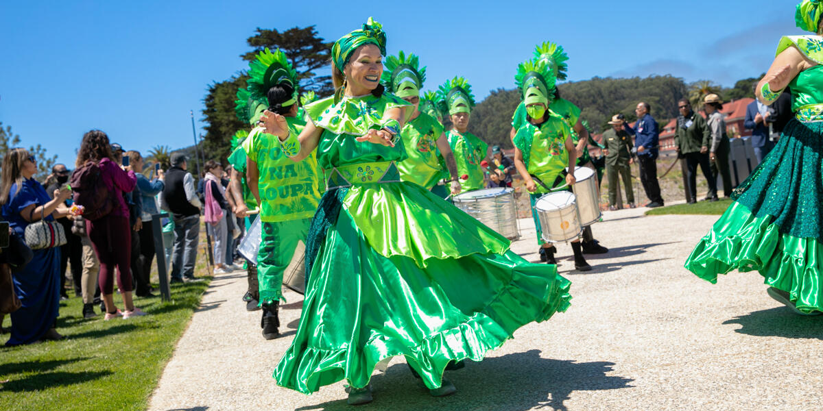 The dancers of Fogo Na Roupa celebrate in bright green regalia at the newly opened Presidio Tunnel Tops.