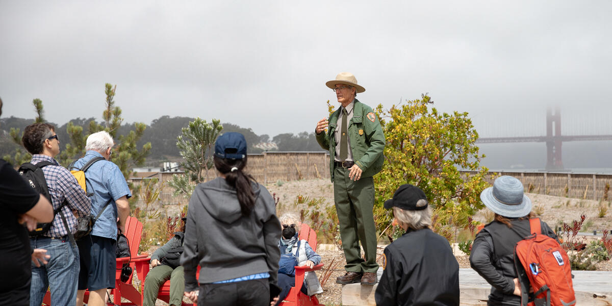 A Golden Gate National Recreation Area Park Ranger leads a discussion at Presidio Tunnel Tops Campfire Circle.