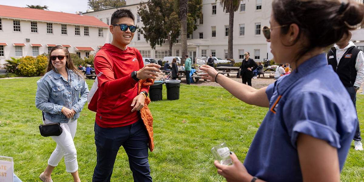 Parks Conservancy staff hand out souvenir beer tasting glasses at Parks4All: Brewfest, a beer festival and fundraiser, on Saturday, July 29th, 2023 in the Presidio of San Francisco. 