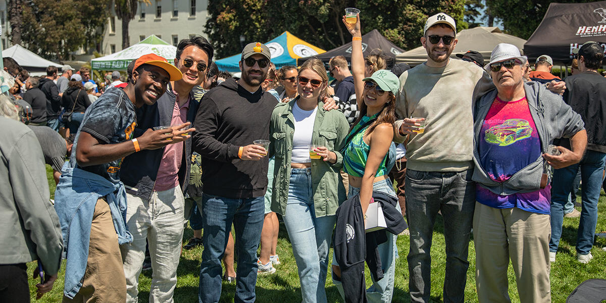 A group of friends line up for a photo at Parks4All: Brewfest, a beer festival and fundraiser, on Saturday, July 29th, 2023 in the Presidio of San Francisco.