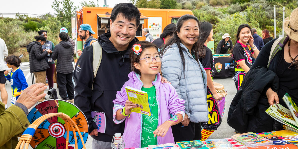A smiling family enjoying activities at Access to Adventure day in the Presidio of San Francisco.