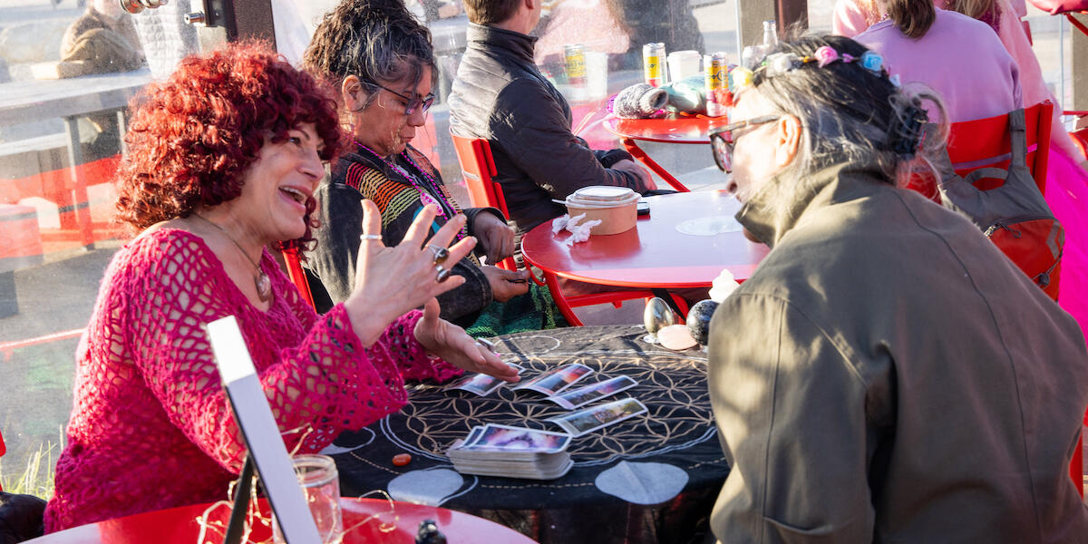 Tarot card reading at Pink Full Moon Party 2025.