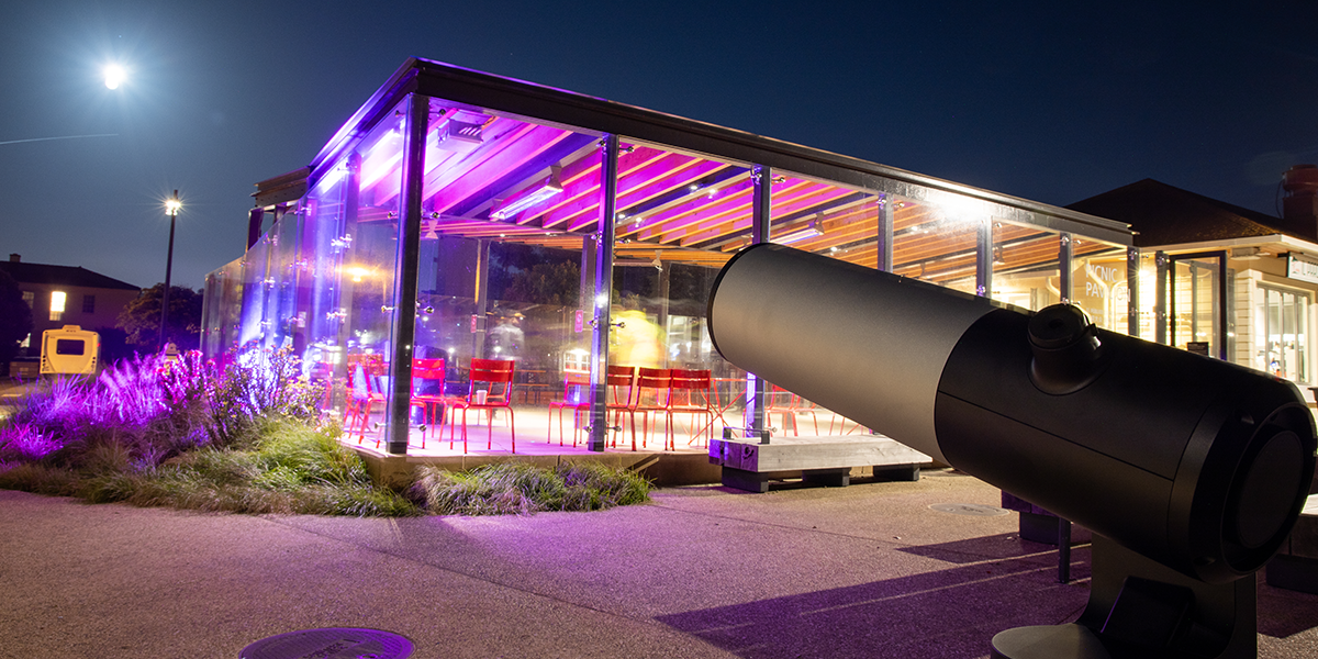 Telescope looks out at the moon at Pink Full Moon Party 2025.