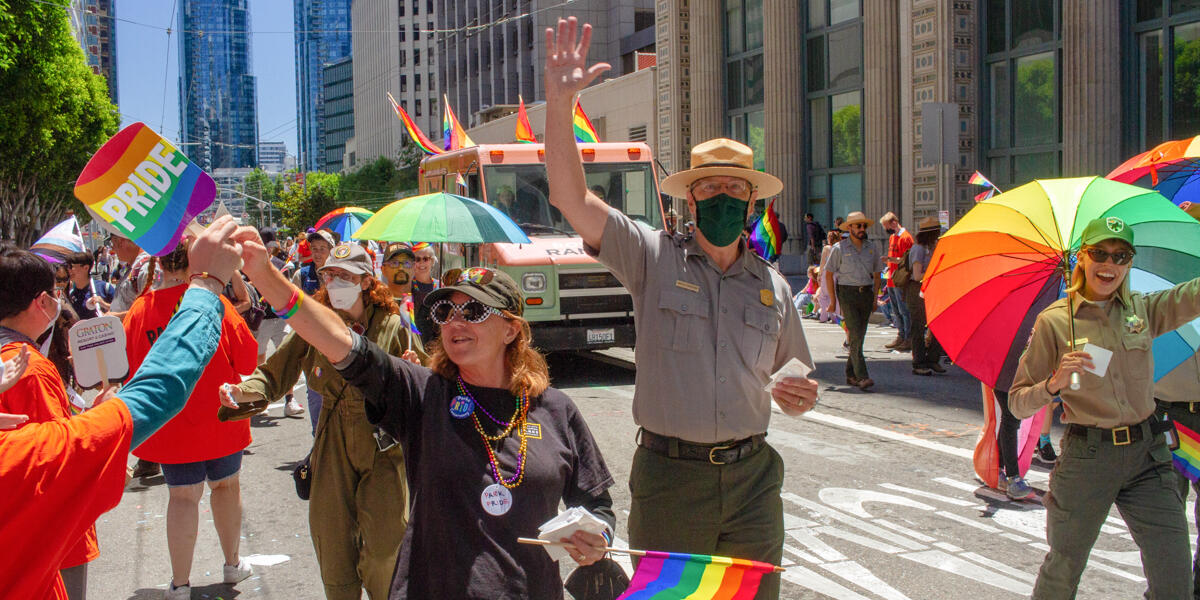 Conservancy, NPS, and Presidio Trust partners handing out stickers at the 2022 SF Pride parade.
