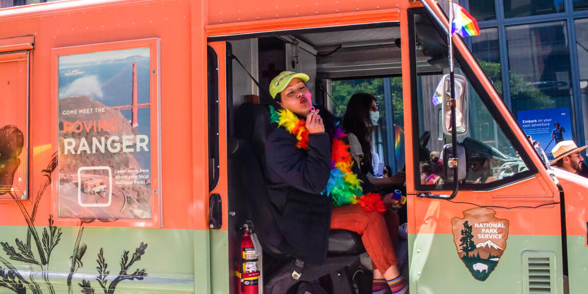 A Conservancy staff member blows bubbles from the Roving Ranger at the 2022 SF Pride parade.