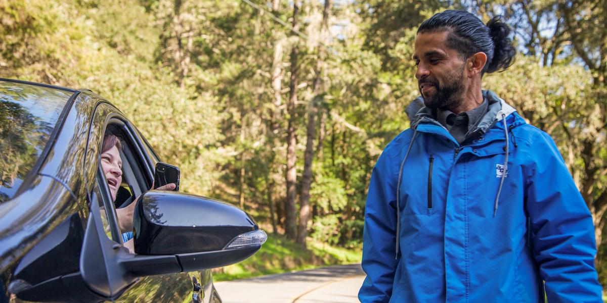 Driver shows Muir Woods parking reservation to attendent 